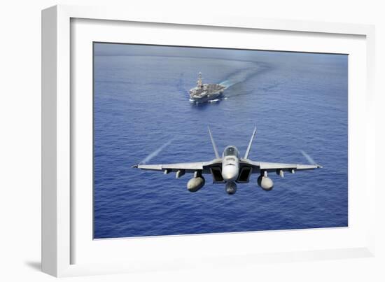 An F-A-18E Super Hornet Flying Above USS John C. Stennis-null-Framed Photographic Print