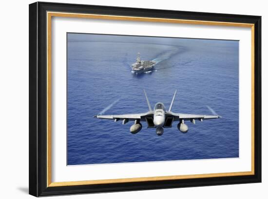 An F-A-18E Super Hornet Flying Above USS John C. Stennis-null-Framed Photographic Print