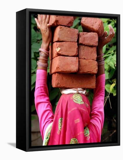 An Indian Woman Construction Worker Stacks Bricks on Her Head-null-Framed Premier Image Canvas