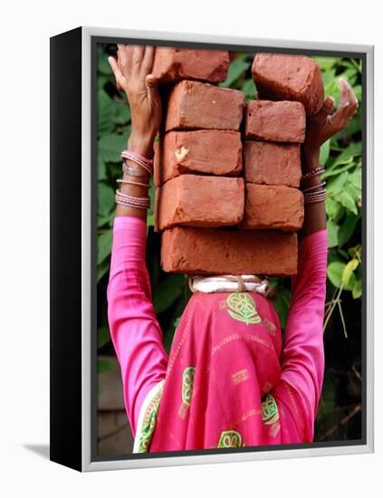 An Indian Woman Construction Worker Stacks Bricks on Her Head-null-Framed Premier Image Canvas