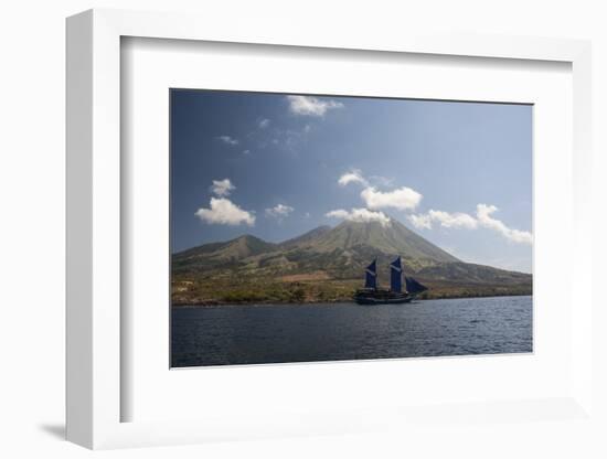 An Indonesian Pinisi Schooner Sails Near a Remote Volcanic Island-Stocktrek Images-Framed Photographic Print