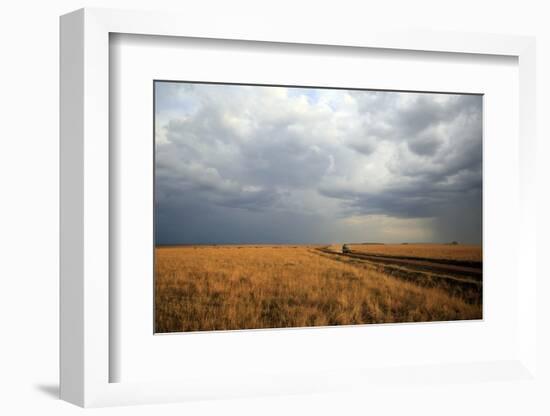 An off-road vehicle driving in the African savanna, Masai Mara Game Reserve, Kenya, East Africa, Af-null-Framed Photographic Print