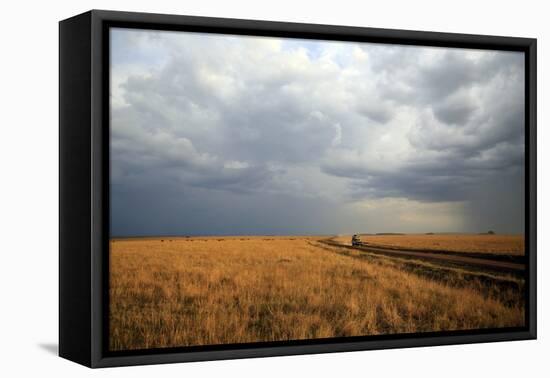 An off-road vehicle driving in the African savanna, Masai Mara Game Reserve, Kenya, East Africa, Af-null-Framed Premier Image Canvas