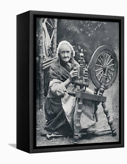 An old Irish woman at her spinning-wheel, 1912-W Lawrence-Framed Premier Image Canvas