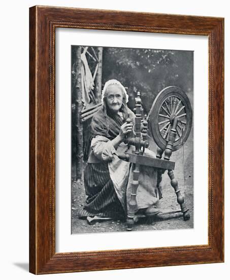 An old Irish woman at her spinning-wheel, 1912-W Lawrence-Framed Photographic Print