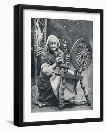 An old Irish woman at her spinning-wheel, 1912-W Lawrence-Framed Photographic Print