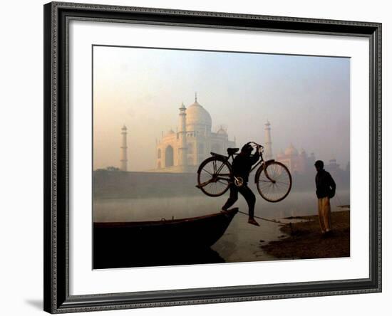 An Unidentified Cyclist Gets Down with His Cycle against the Backdrop of the Taj Mahal-null-Framed Photographic Print