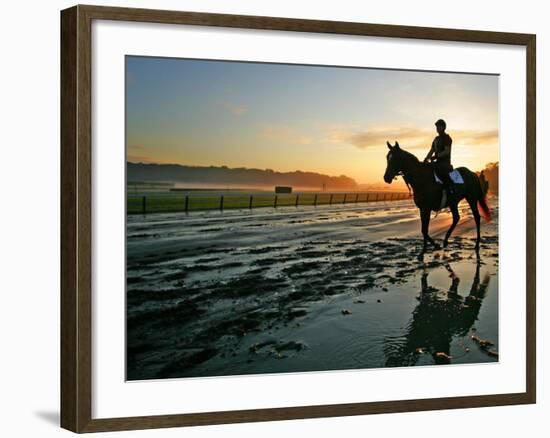 An Unidentified Horse and Rider on the Track at Sunrise at Belmont Park-null-Framed Photographic Print