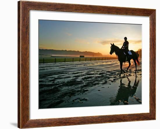 An Unidentified Horse and Rider on the Track at Sunrise at Belmont Park-null-Framed Photographic Print