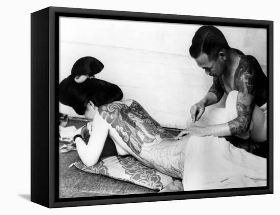 An Unidentified Japanese Tattoo Artist Works on a Woman's Backside-null-Framed Premier Image Canvas