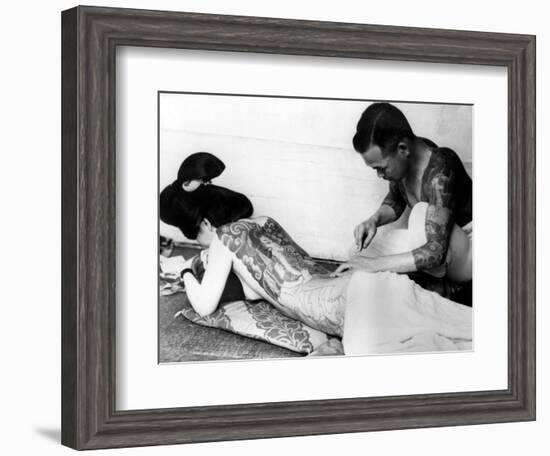 An Unidentified Japanese Tattoo Artist Works on a Woman's Backside--Framed Photographic Print
