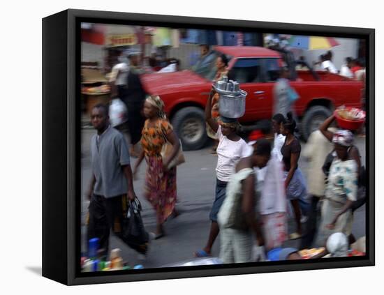 An Water Vendor Walks in the Streets of Port-Au-Prince, Haiti-null-Framed Premier Image Canvas