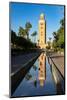 Ancient minaret tower of Koutoubia Mosque, reflected in water in a palm fringed park-Roberto Moiola-Mounted Photographic Print