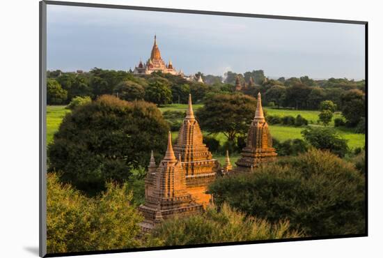 Ancient temple and pagoda rising out of the jungle at sunrise, Bagan, Mandalay Region, Myanmar-Keren Su-Mounted Photographic Print