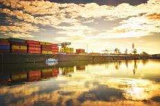One of Main River's side channels with stacked containers and golden reflections in an industrial s-Andreas Brandl-Photographic Print