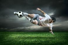 Football Player with Ball in Action Outdoors-Andrey Yurlov-Photographic Print