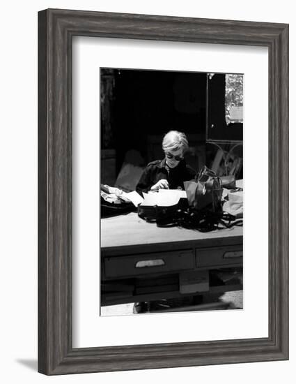 Andy at Typewriter, The Factory, NYC, circa 1965-Andy Warhol/ Nat Finkelstein-Framed Art Print