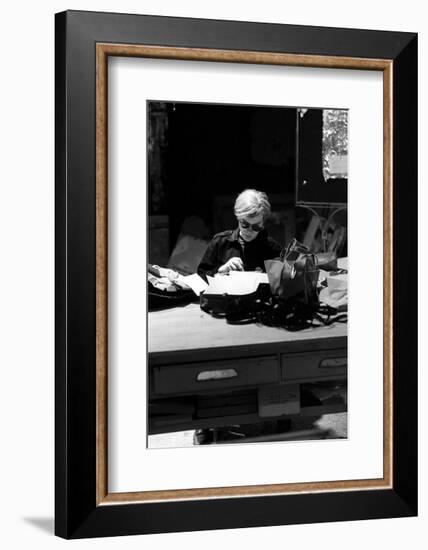 Andy at Typewriter, The Factory, NYC, circa 1965-Andy Warhol/ Nat Finkelstein-Framed Art Print