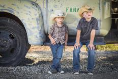 Two Young Boys Wearing Cowboy Hats Leaning against an Antique Truck in a Rustic Country Setting.-Andy Dean Photography-Photographic Print