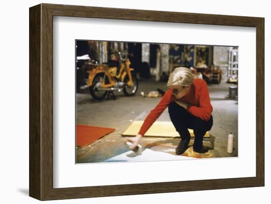 Andy with Spray Paint and Moped, The Factory, NYC, circa 1965-Nat Finkelstein-Framed Art Print