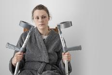 Woman Watching TV with Crutches-Anthony West-Photographic Print