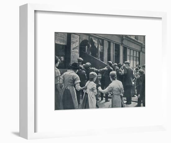 Anti-German rioting in London: A crowd breaking in the windows of a German shop', c1914-Unknown-Framed Photographic Print