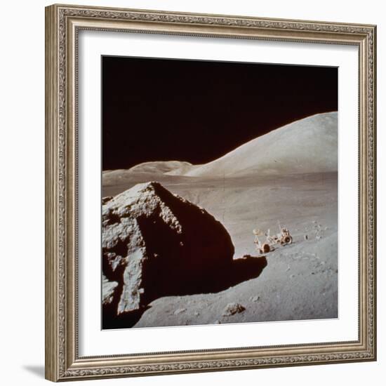 Apollo 17's Rover, a Lunar Vehicle, on the Surface of the Moon Next to Giant Rock-null-Framed Photographic Print