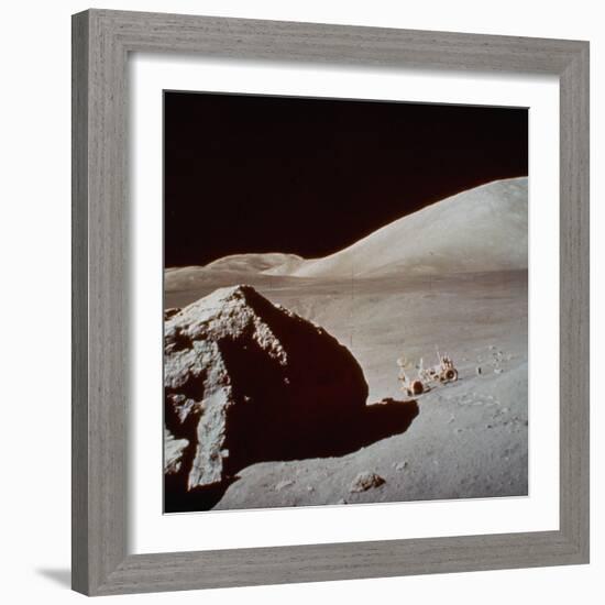 Apollo 17's Rover, a Lunar Vehicle, on the Surface of the Moon Next to Giant Rock-null-Framed Photographic Print