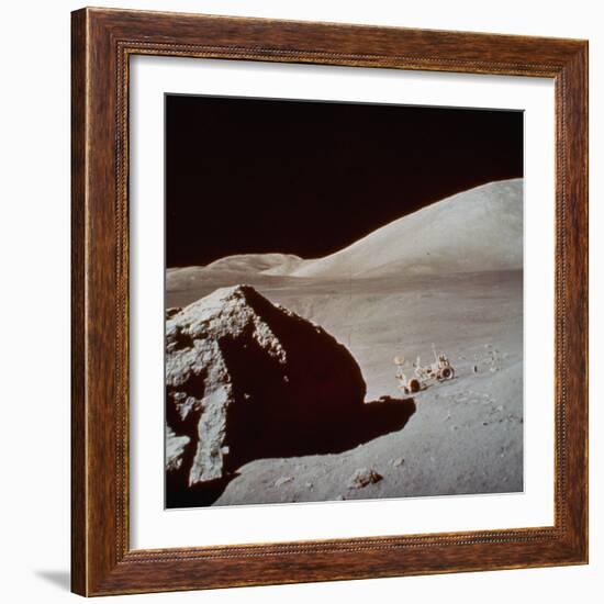 Apollo 17's Rover, a Lunar Vehicle, on the Surface of the Moon Next to Giant Rock-null-Framed Photographic Print