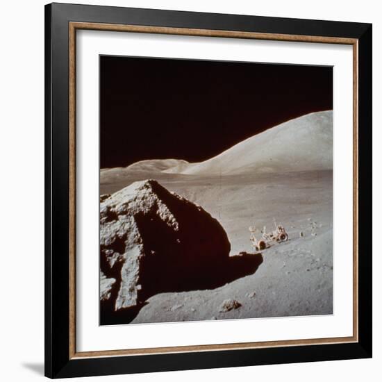 Apollo 17's Rover, a Lunar Vehicle, on the Surface of the Moon Next to Giant Rock-null-Framed Photographic Print