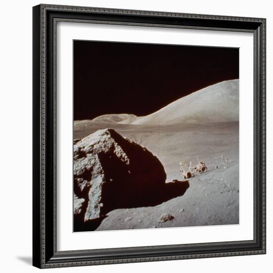 Apollo 17's Rover, a Lunar Vehicle, on the Surface of the Moon Next to Giant Rock-null-Framed Photographic Print