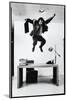 Architect and Designer Frank Gehry Jumping on a Desk in His Line of Cardboard Furniture-Ralph Morse-Mounted Photographic Print