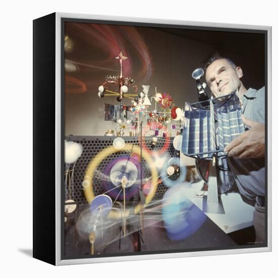 Architect/Designer Charles Eames with Engine that Generates Solar Power to Run Toys Surrounding Him-Ralph Crane-Framed Premier Image Canvas