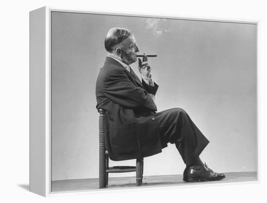 Architect Frederick Kiesler Seated in a Child's Chair, Smoking a Cigar, at Gjon Mili's Studio-Gjon Mili-Framed Premier Image Canvas