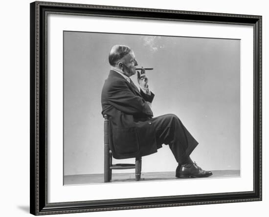 Architect Frederick Kiesler Seated in a Child's Chair, Smoking a Cigar, at Gjon Mili's Studio-Gjon Mili-Framed Premium Photographic Print