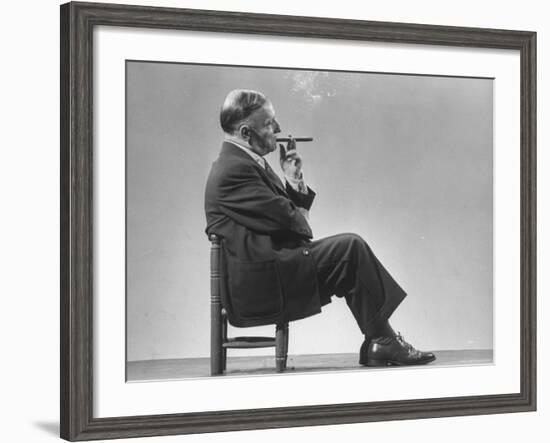 Architect Frederick Kiesler Seated in a Child's Chair, Smoking a Cigar, at Gjon Mili's Studio-Gjon Mili-Framed Premium Photographic Print