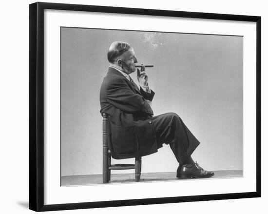 Architect Frederick Kiesler Seated in a Child's Chair, Smoking a Cigar, at Gjon Mili's Studio-Gjon Mili-Framed Premium Photographic Print