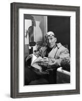Architect Le Corbusier Sitting in Chair and Holding Book in Hands-Nina Leen-Framed Premium Photographic Print