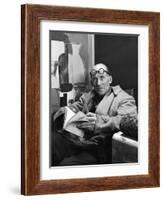 Architect Le Corbusier Sitting in Chair and Holding Book in Hands-Nina Leen-Framed Premium Photographic Print