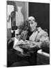 Architect Le Corbusier Sitting in Chair and Holding Book in Hands-Nina Leen-Mounted Premium Photographic Print