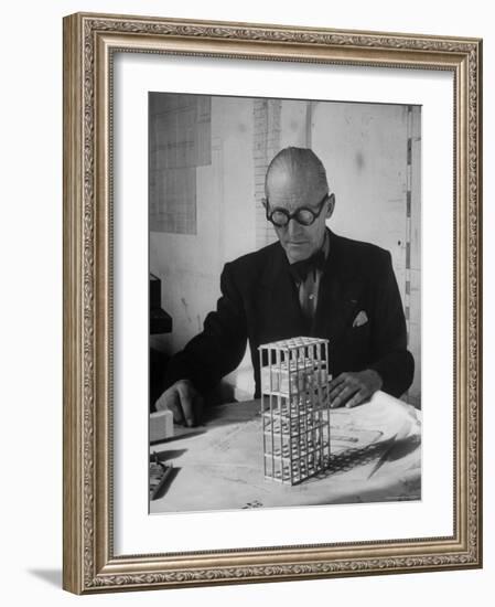 Architect Le Corbusier Studying Architectural Plans and Small Model of Building in His Office-Nina Leen-Framed Premium Photographic Print