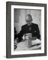 Architect Le Corbusier Studying Architectural Plans and Small Model of Building in His Office-Nina Leen-Framed Premium Photographic Print