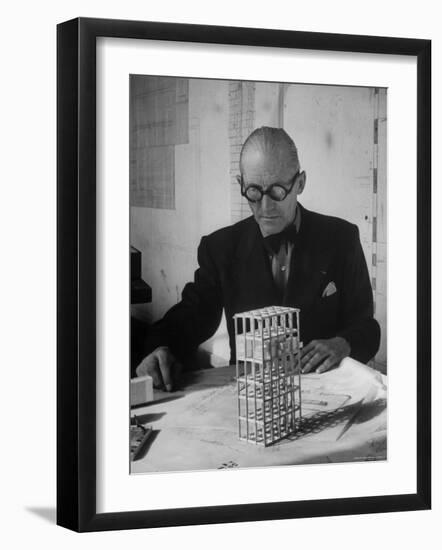 Architect Le Corbusier Studying Architectural Plans and Small Model of Building in His Office-Nina Leen-Framed Premium Photographic Print