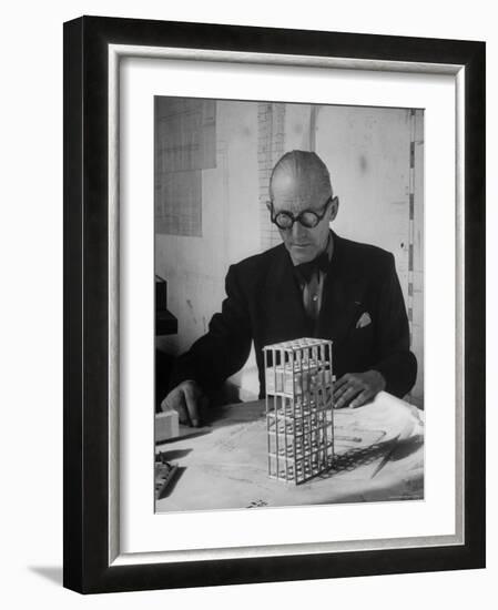Architect Le Corbusier Studying Architectural Plans and Small Model of Building in His Office-Nina Leen-Framed Premium Photographic Print