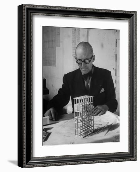 Architect Le Corbusier Studying Architectural Plans and Small Model of Building in His Office-Nina Leen-Framed Premium Photographic Print