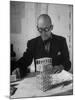 Architect Le Corbusier Studying Architectural Plans and Small Model of Building in His Office-Nina Leen-Mounted Premium Photographic Print