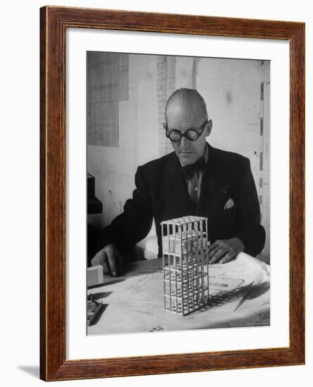 Architect Le Corbusier Studying Architectural Plans and Small Model of Building in His Office-Nina Leen-Framed Premium Photographic Print