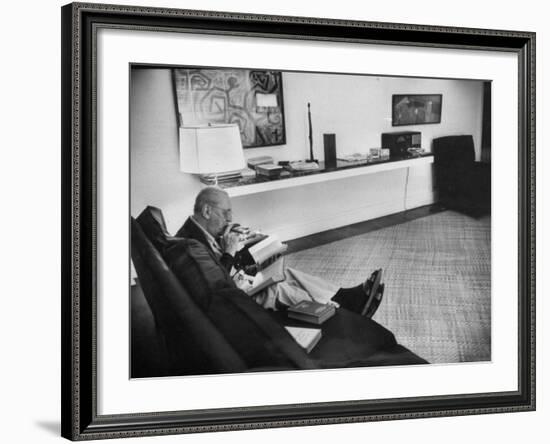 Architect Mies Van Der Rohe Relaxing on Couch While Smoking Cigar and Reading at Home-null-Framed Premium Photographic Print