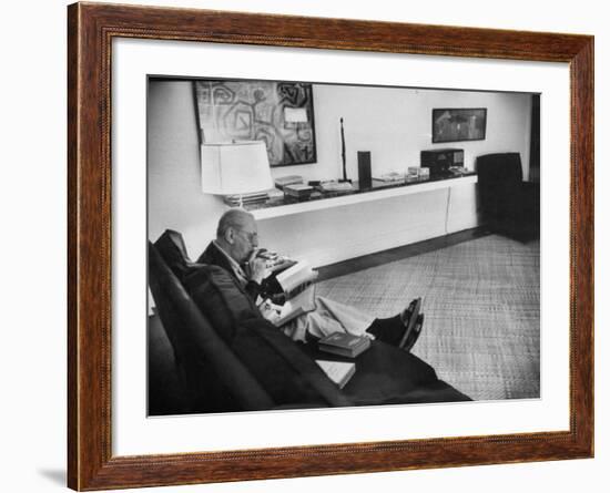 Architect Mies Van Der Rohe Relaxing on Couch While Smoking Cigar and Reading at Home-null-Framed Premium Photographic Print