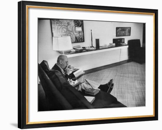 Architect Mies Van Der Rohe Relaxing on Couch While Smoking Cigar and Reading at Home-null-Framed Premium Photographic Print